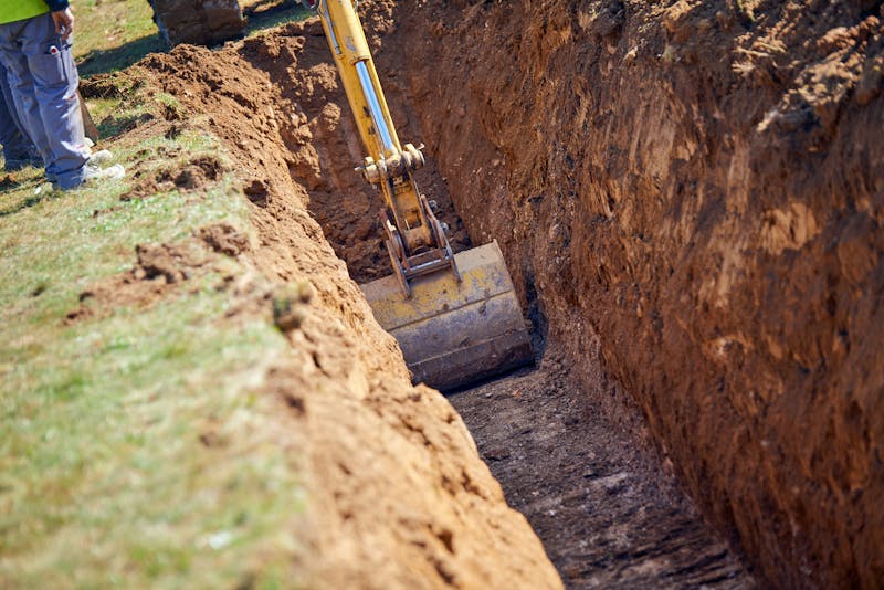 A worker digging a trench