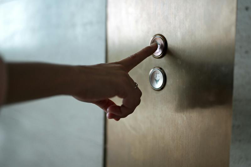 Person pressing elevator button