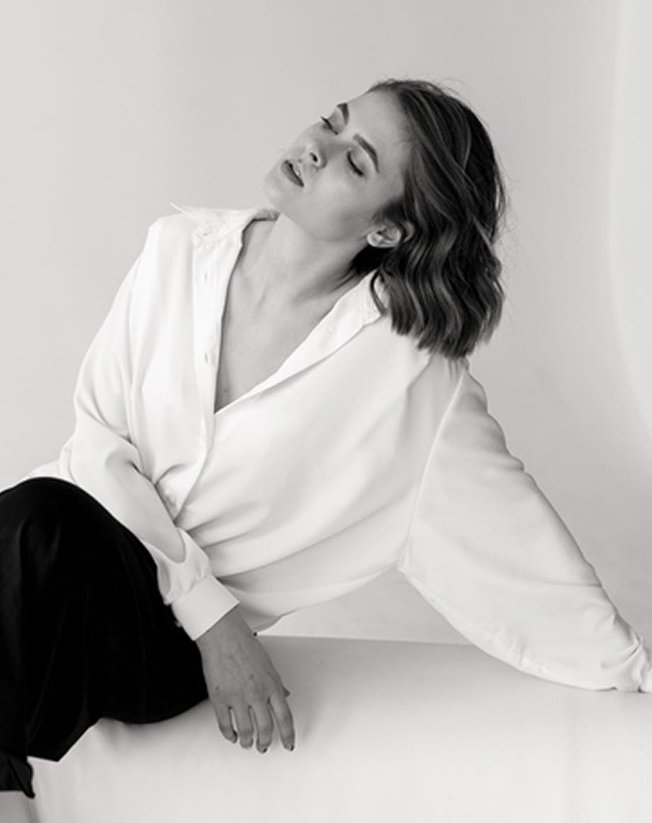 Woman sitting on a couch with eyes closed and head back
