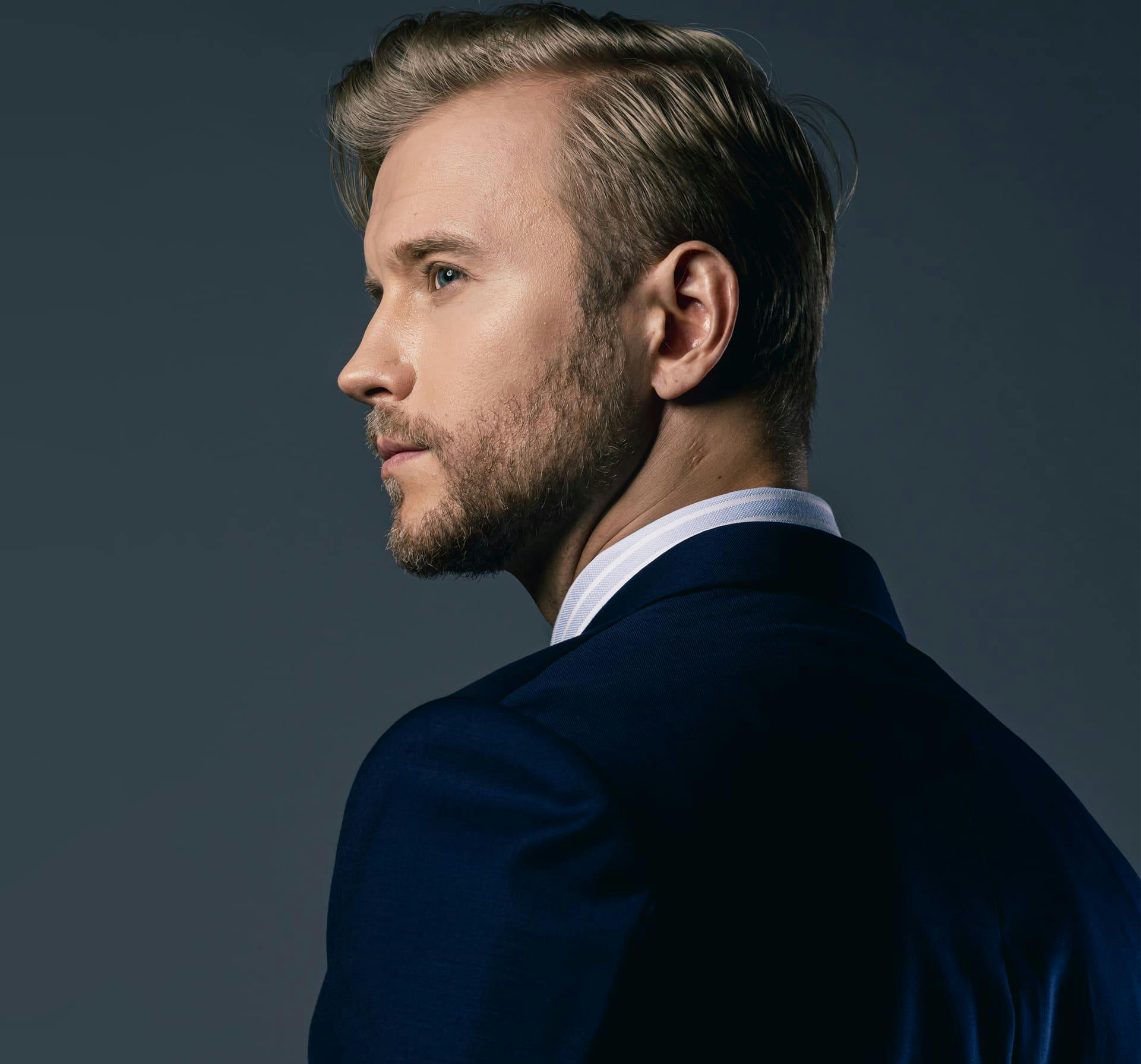 Man in suit looking over shoulder