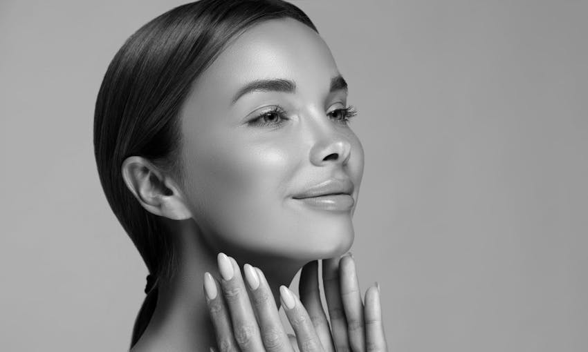 Woman smiling and touching face