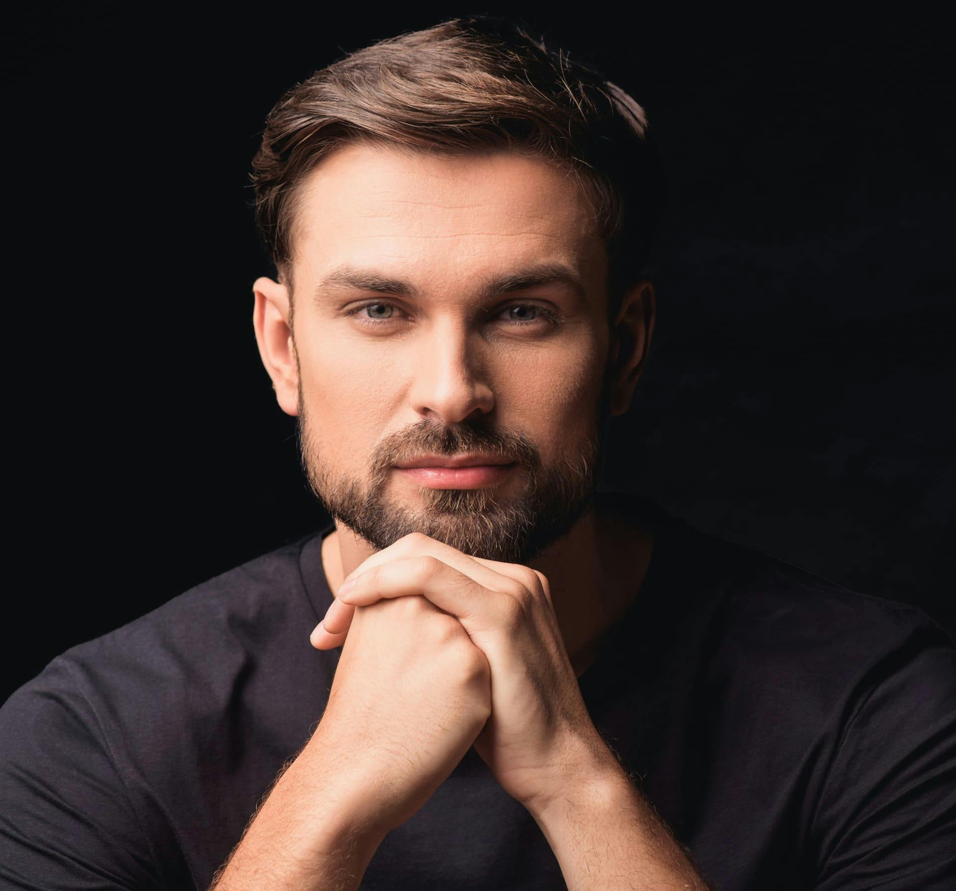 Man resting chin on hands smiling