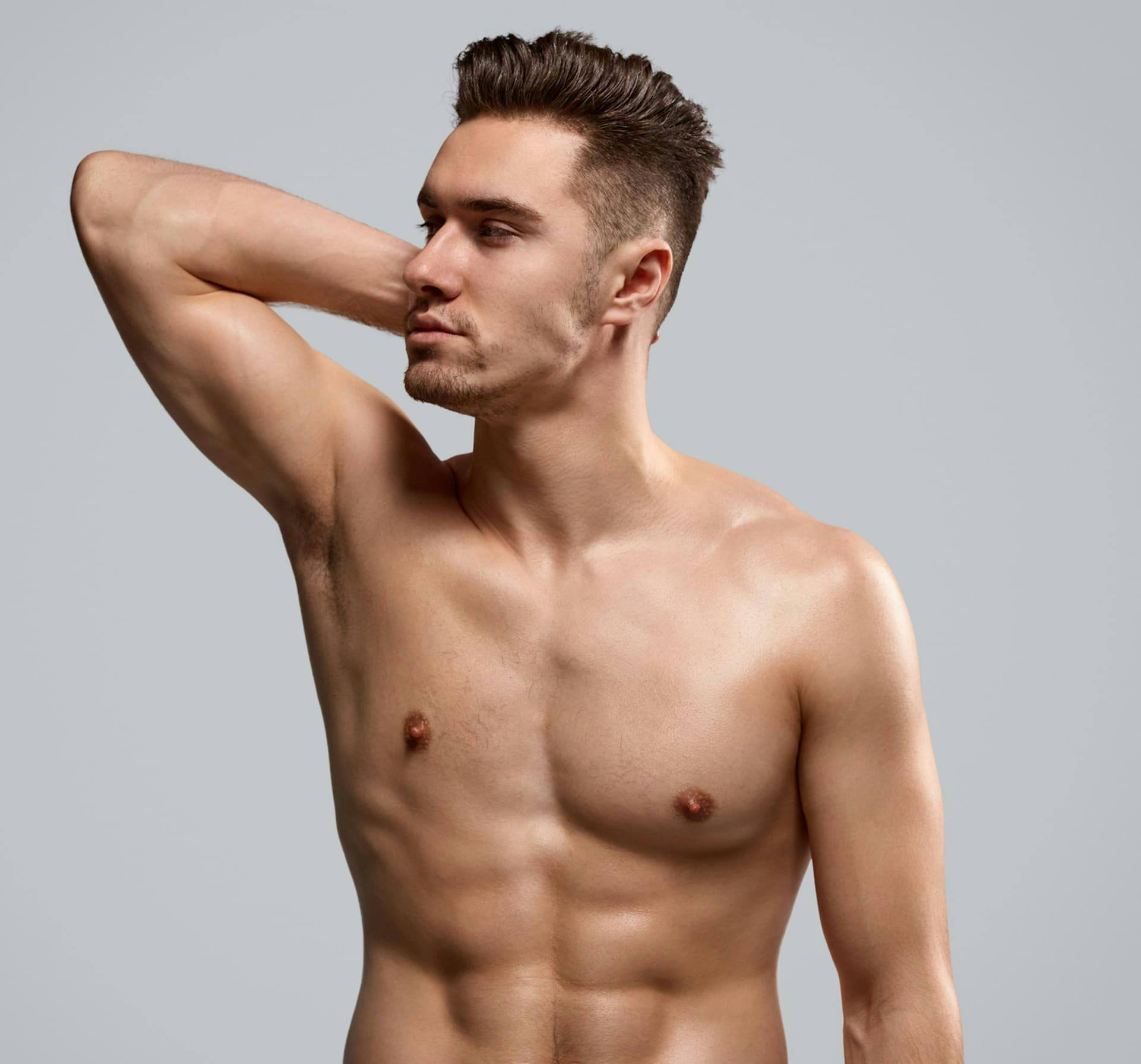 Shirtless man with hand behind head