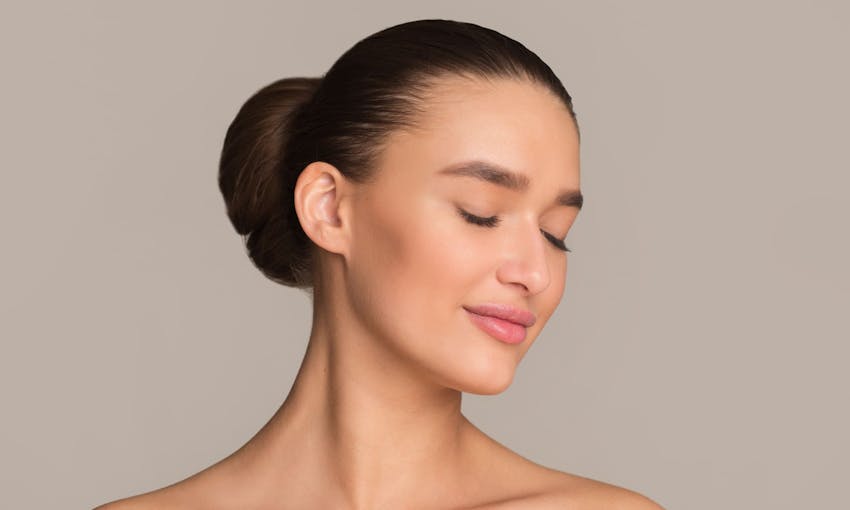 Woman with eyes closed smiling