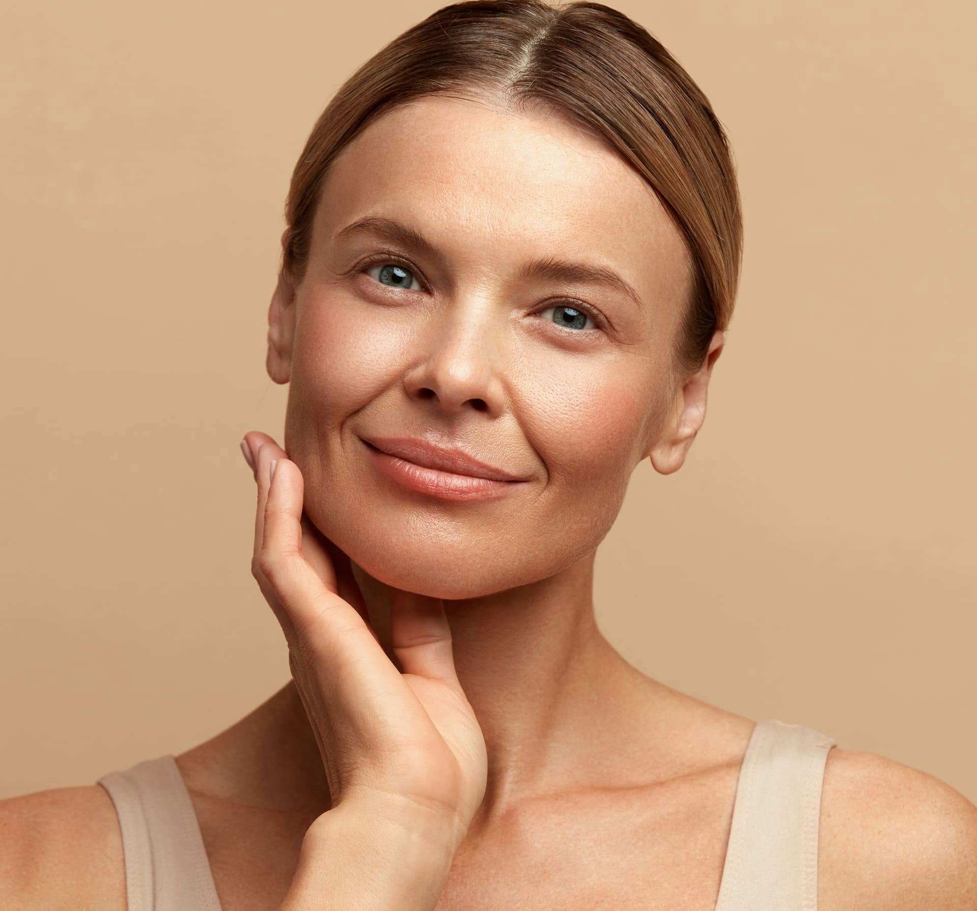 Woman smiling with hand on chin