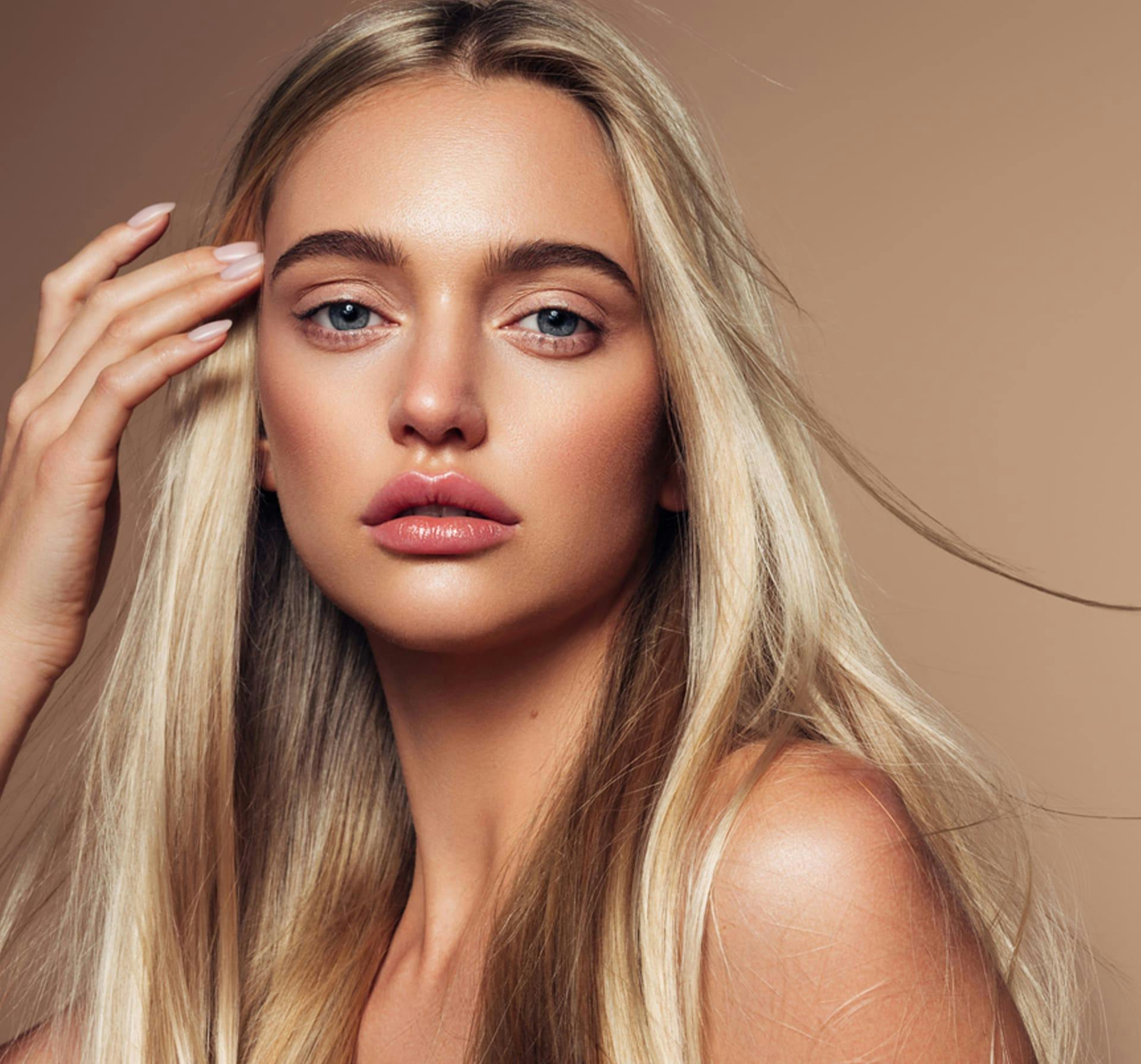 Woman brushing hair aside