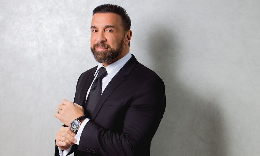 Doctor smiling touching watch