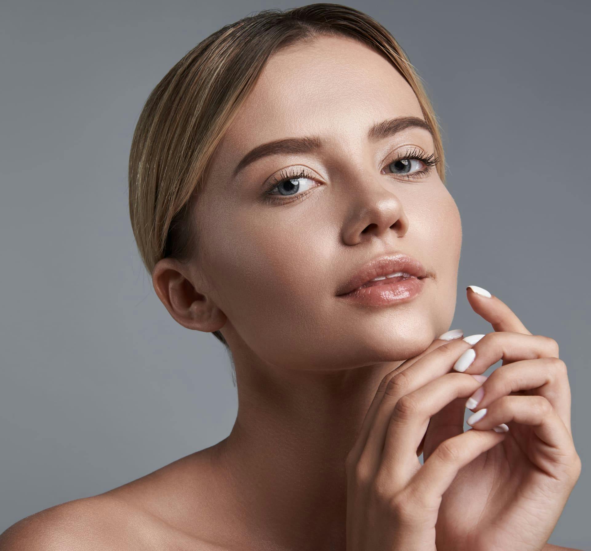 Woman touching chin with both hands