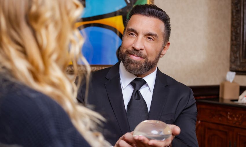 Doctor holding implant