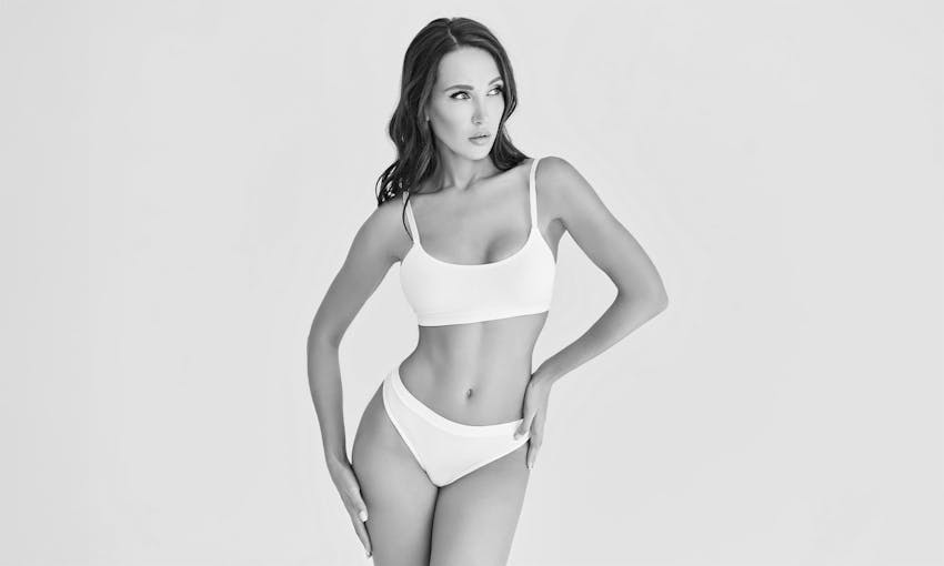 Woman crossing arms and looking up with eyes closed