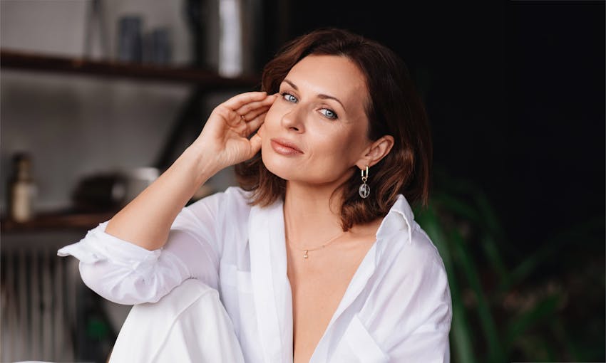 woman in a white button up top