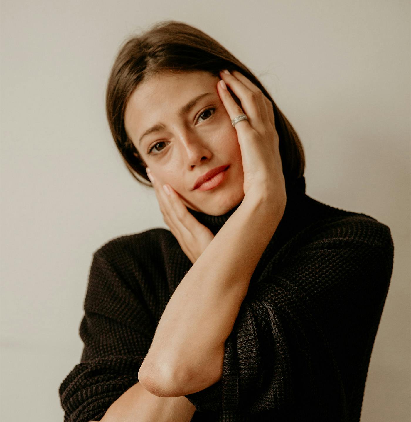 Woman touching the sides of her face