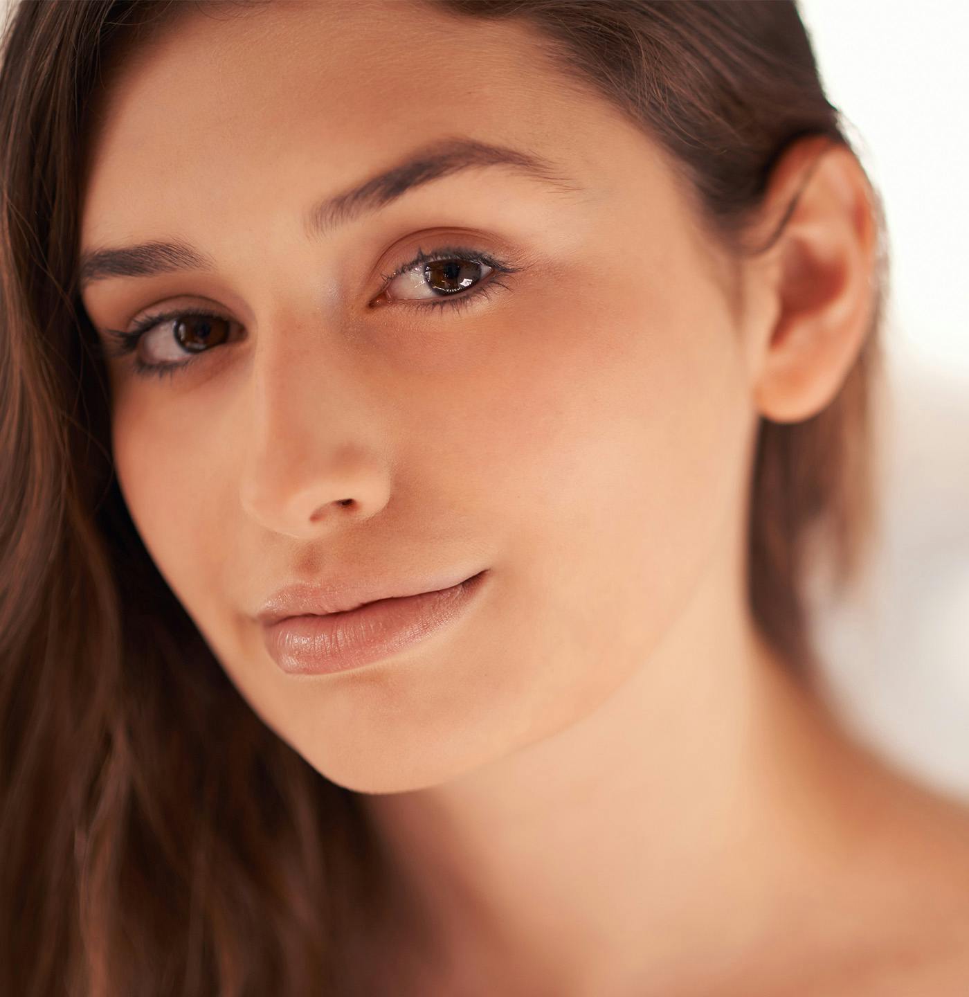Woman with her hair tucked behind her ear