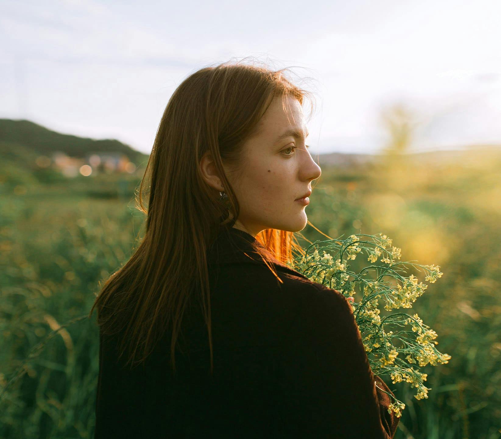 woman outdoors holding some flowers