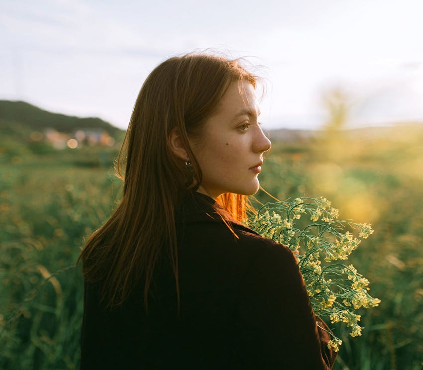 woman outdoors holding some flowers