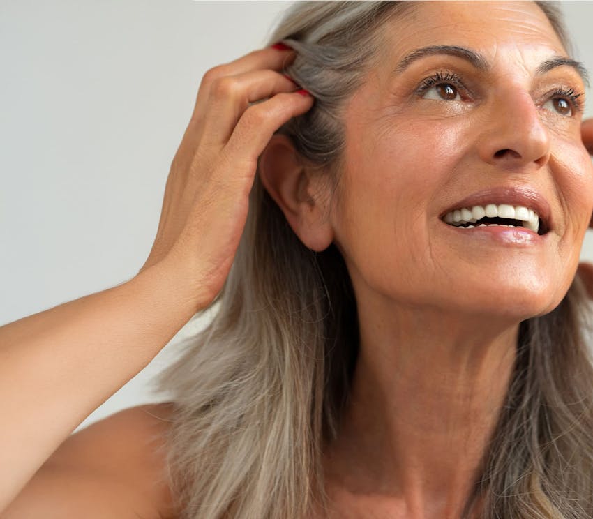 woman moving her hair out of the way and looking up