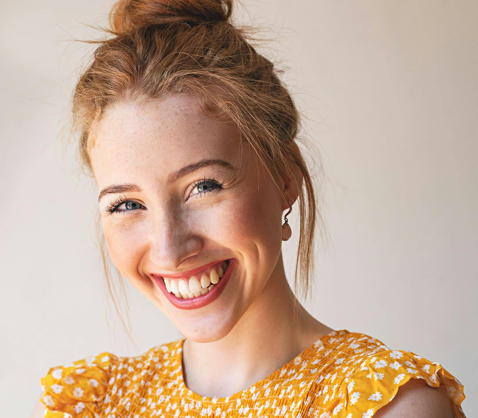 woman in yellow top smiling