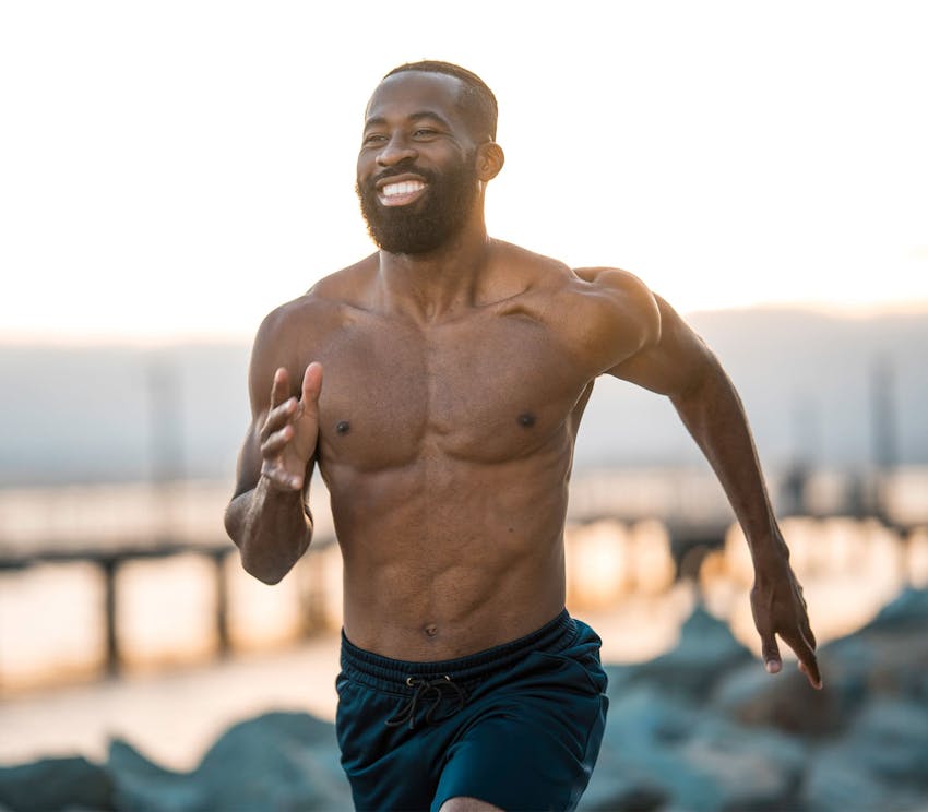 man smiling and runnning outside