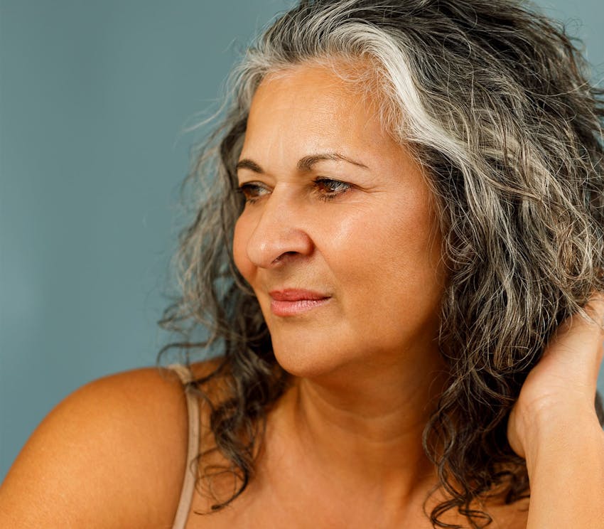 woman with gray hair looking to the left