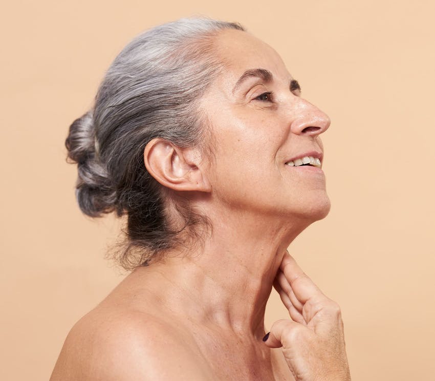 side profile of older woman with bun