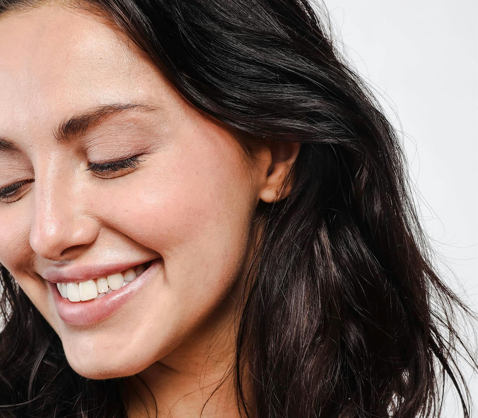 woman smiling and looking down