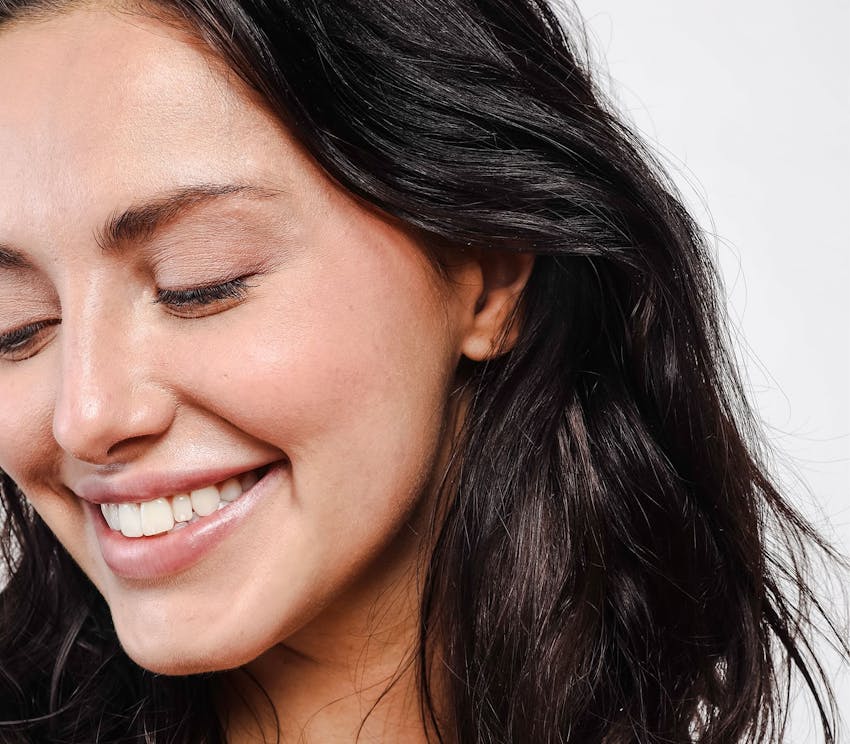 woman smiling and looking down
