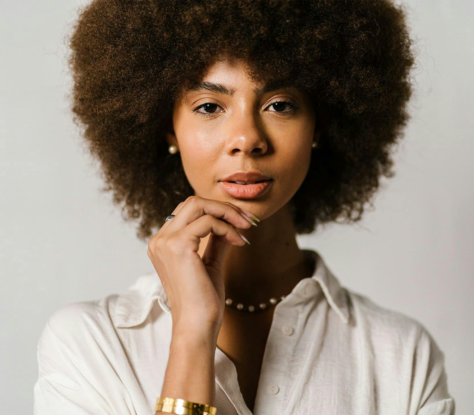 Woman touching chin with hand