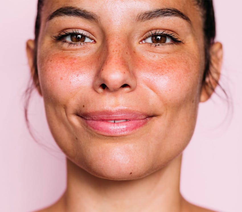 close up on woman's face while grinning
