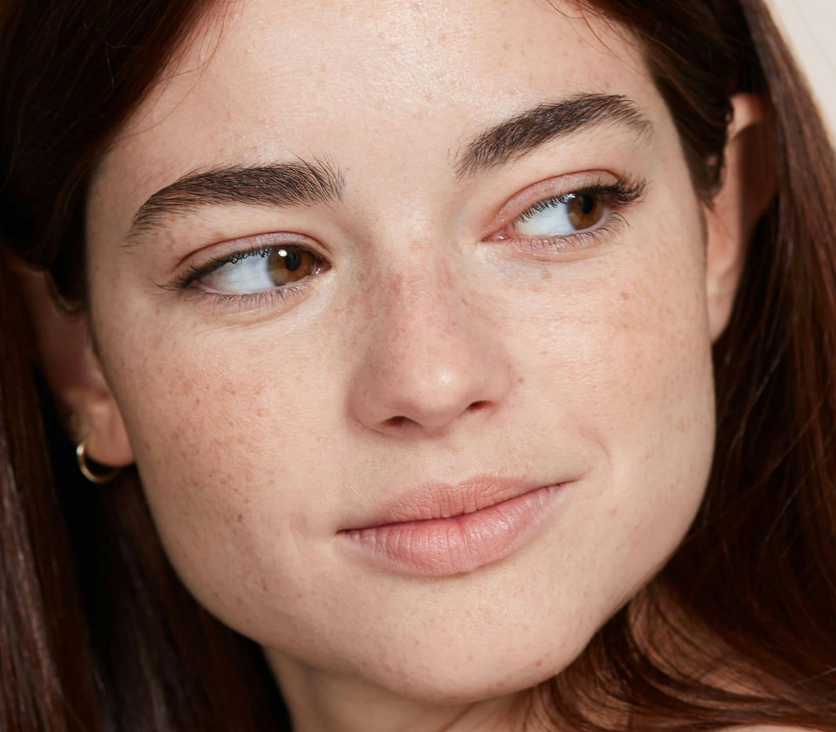 close up on woman's face looking to the right
