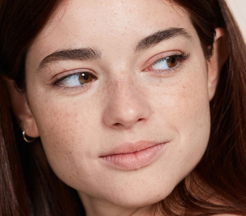 close up on woman's face looking to the right