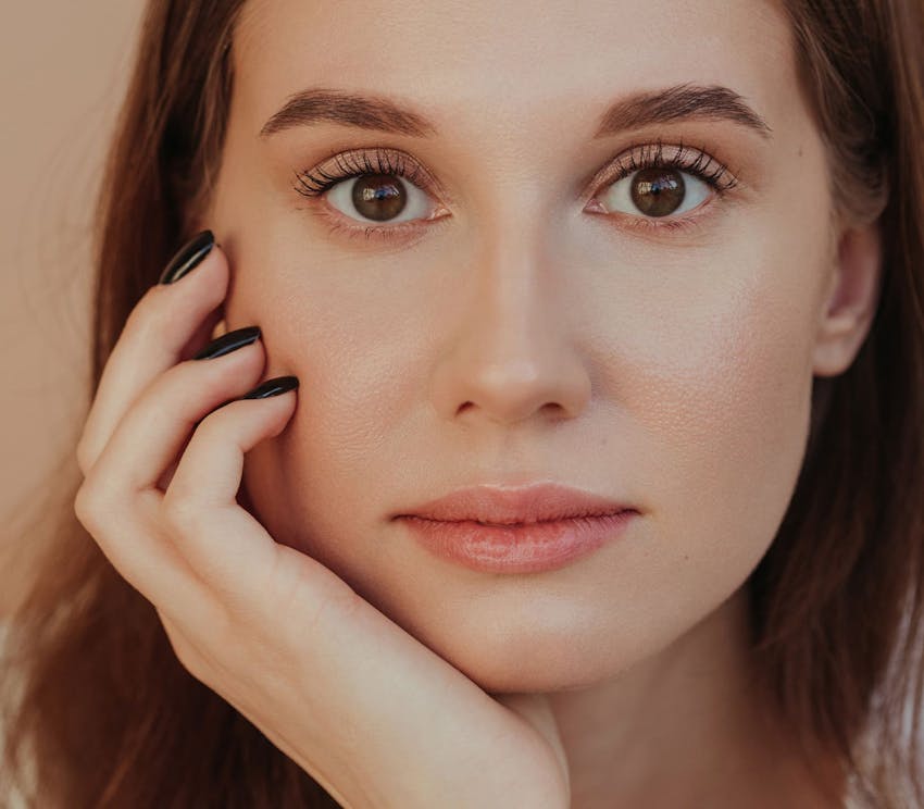close up of woman resting her head on her hand