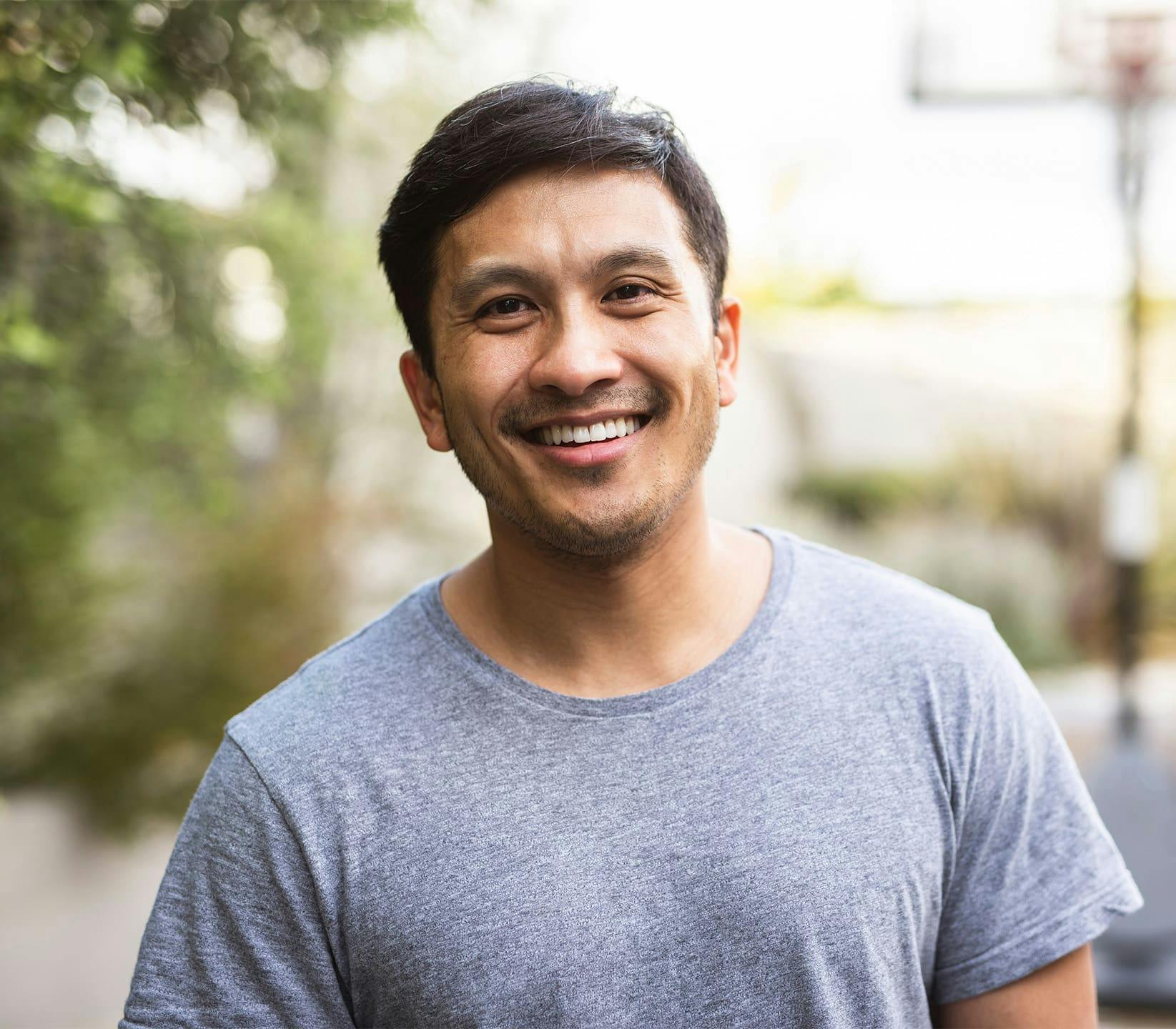 man smiling with grey t-shirt on