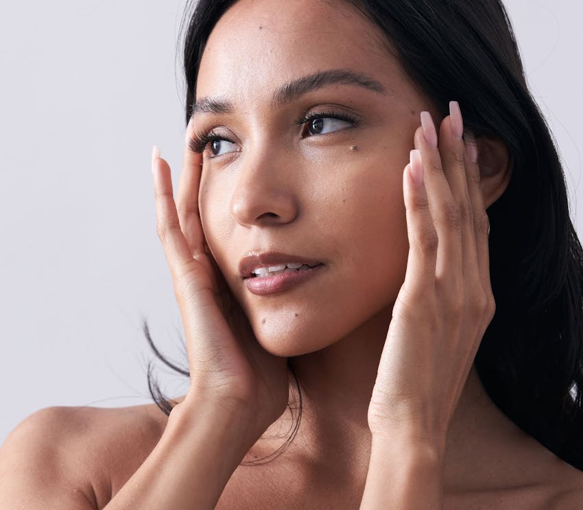 Woman touching sides of face