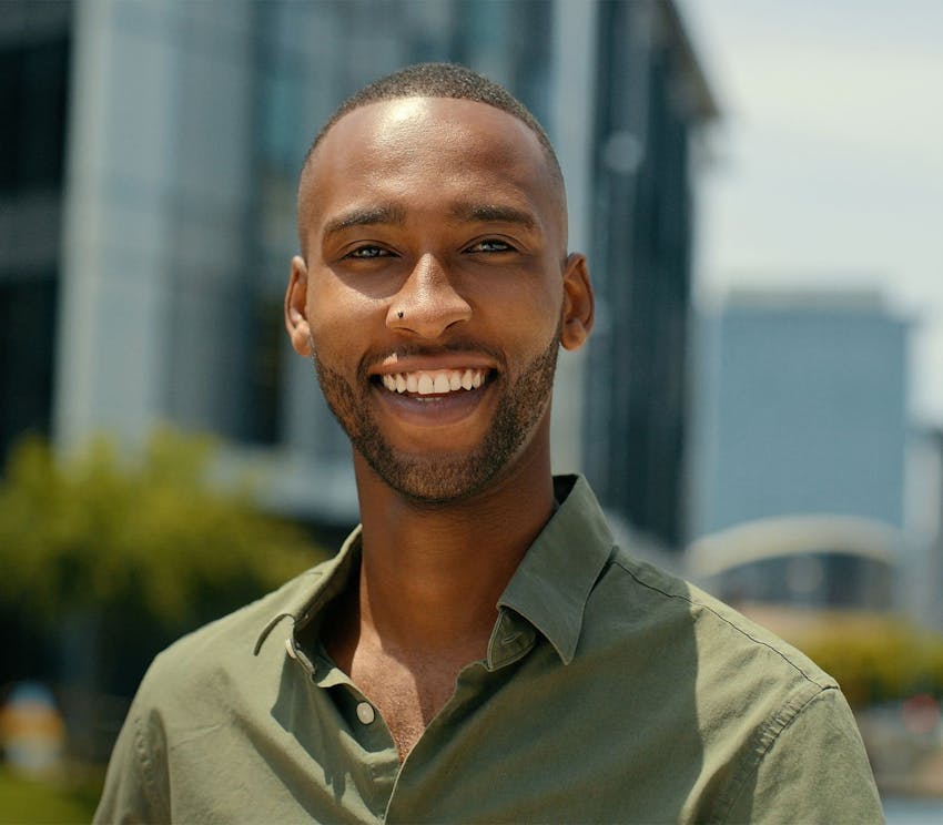 man smiling with green shirt on