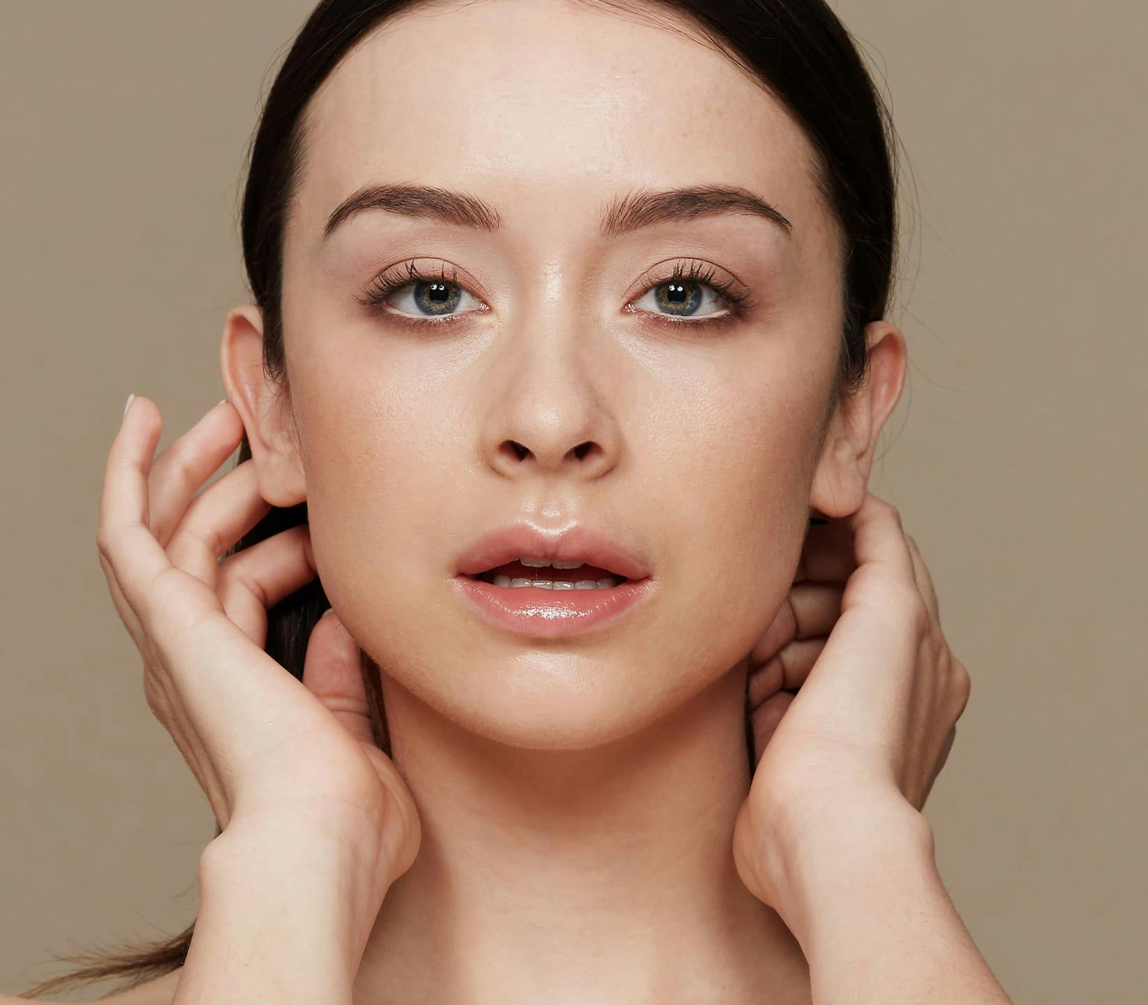 woman facing forward moving her hair back