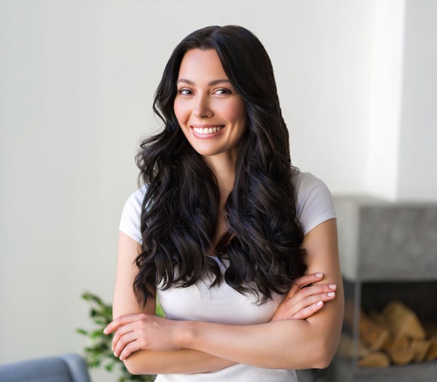 woman smiling with her arms crossed