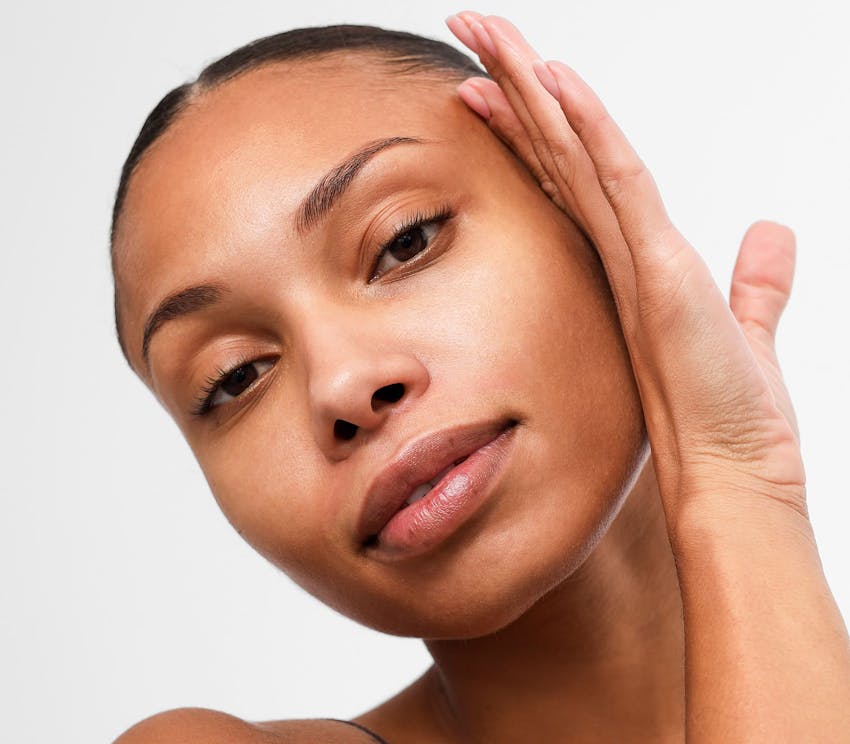 woman touching her face