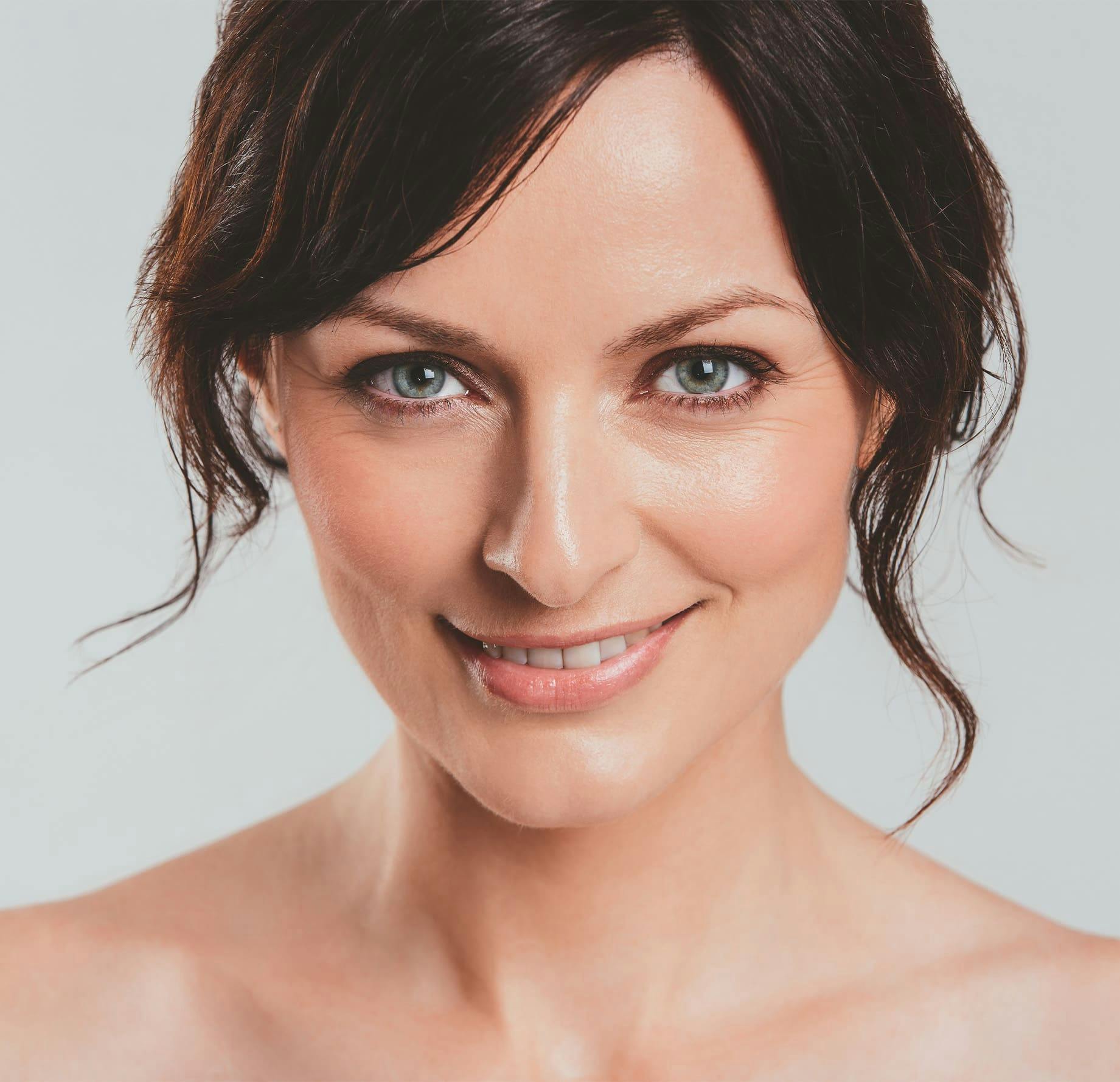 woman facing forward and smirking