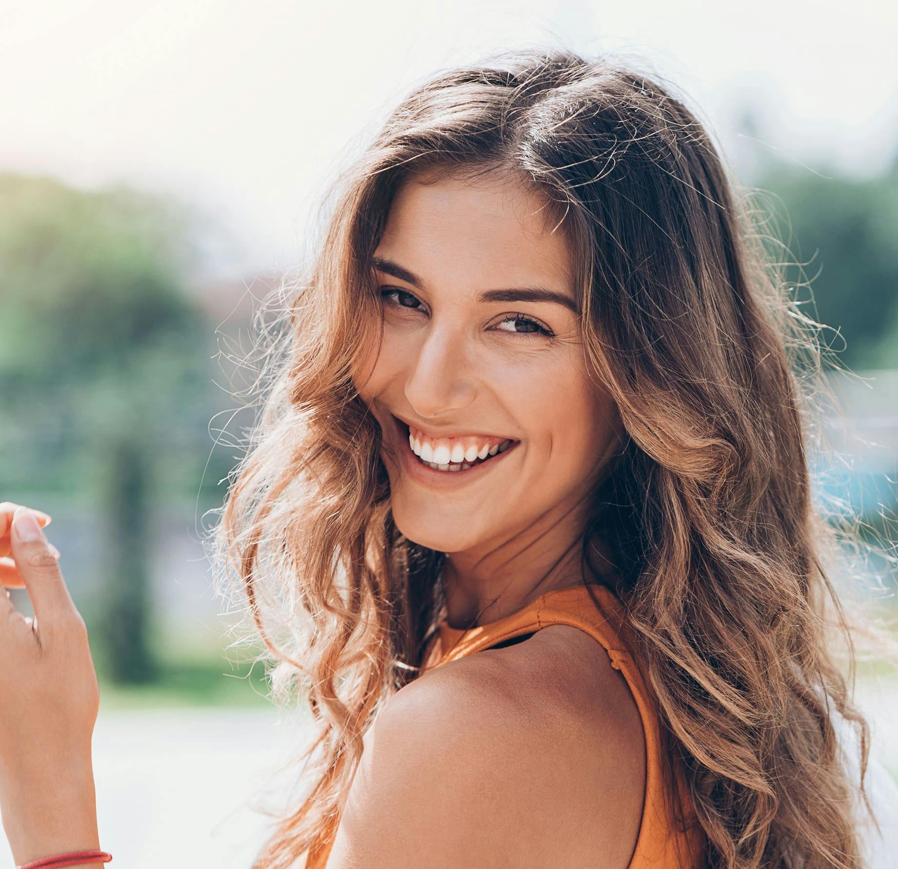 woman smiling and looking over her shoulder