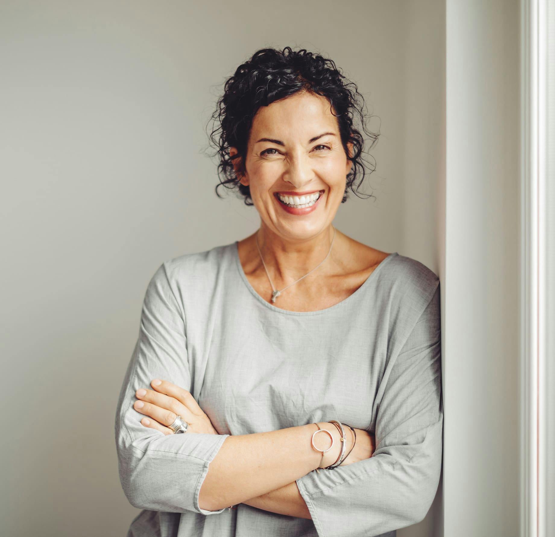 Woman smiling with her arms crossed