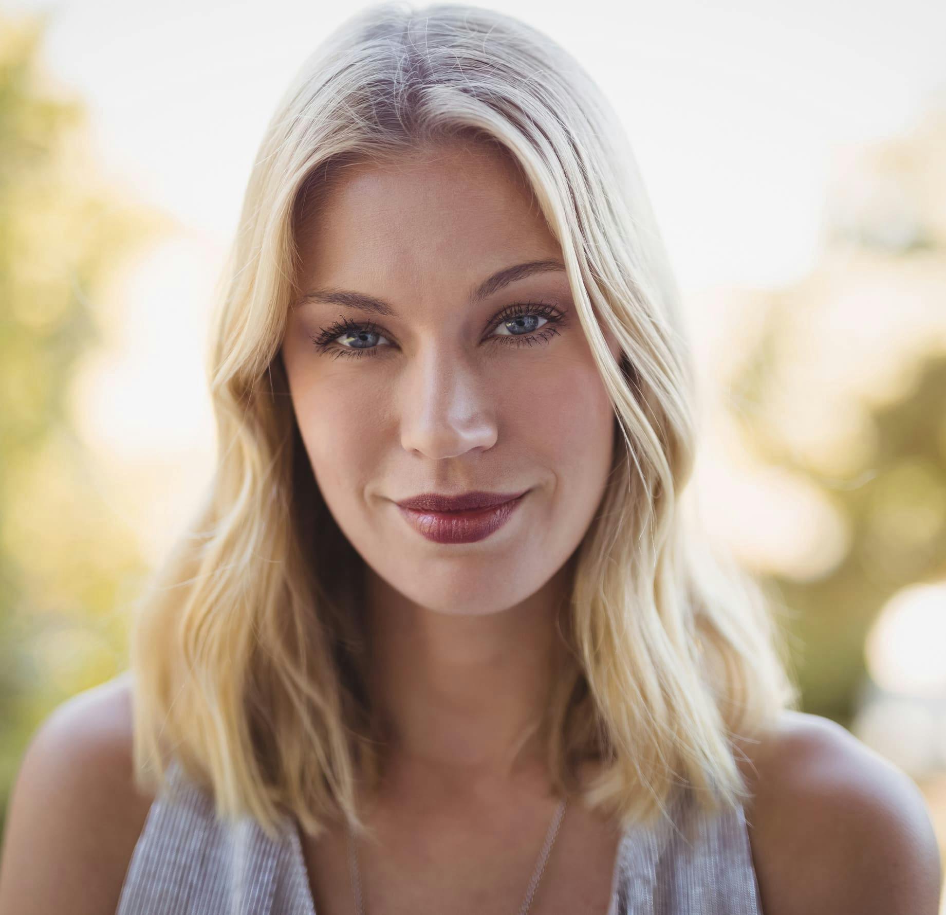 woman with shoulder-length blonde hair looking forward