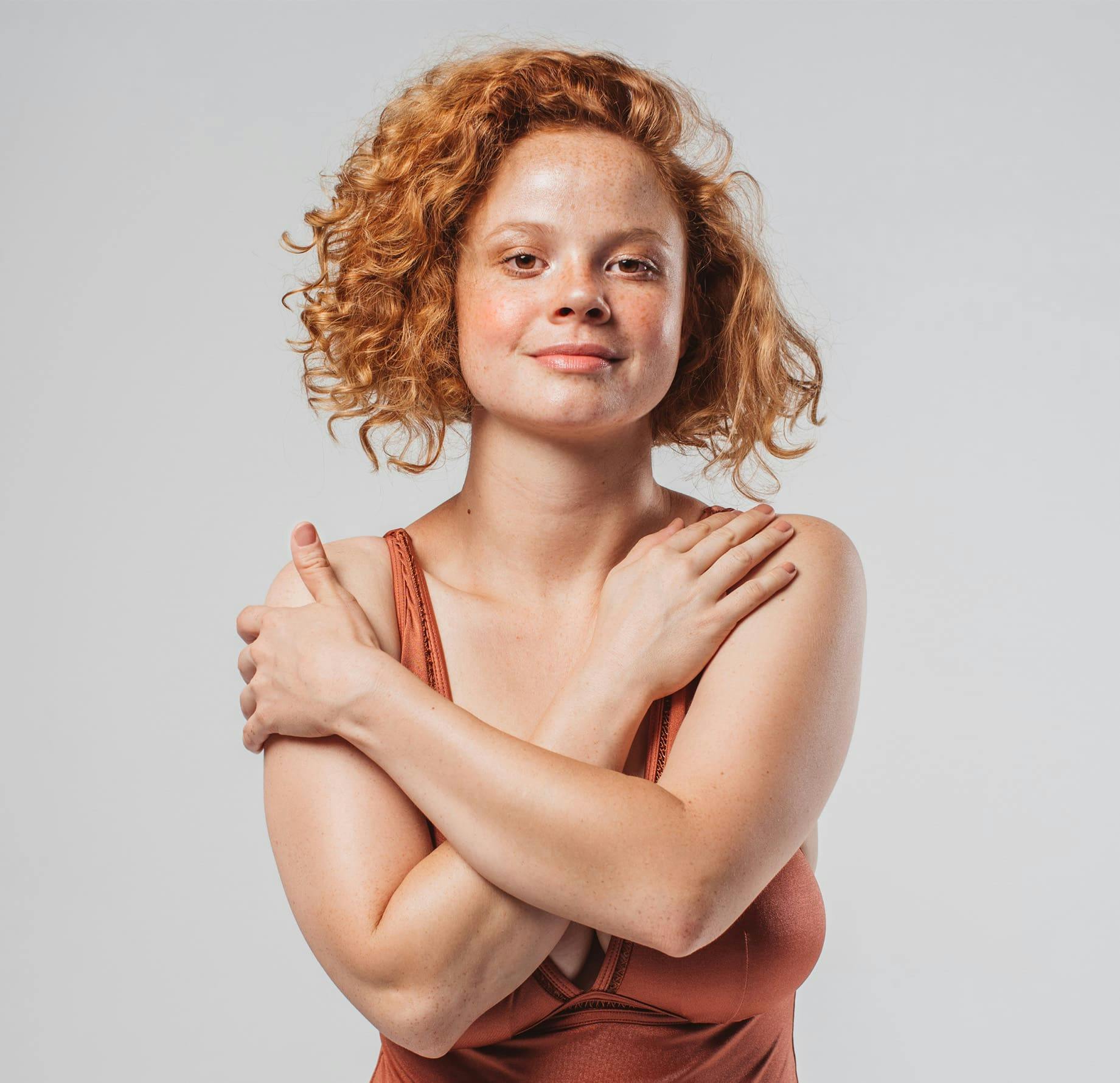 Woman with arms crossed smiling