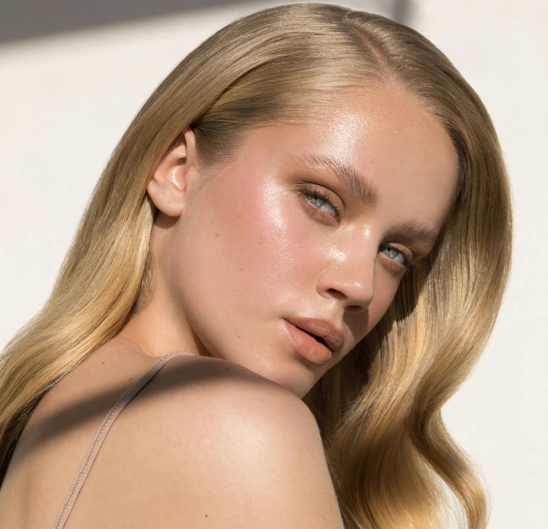 Woman in the sunlight looking over her shoulder