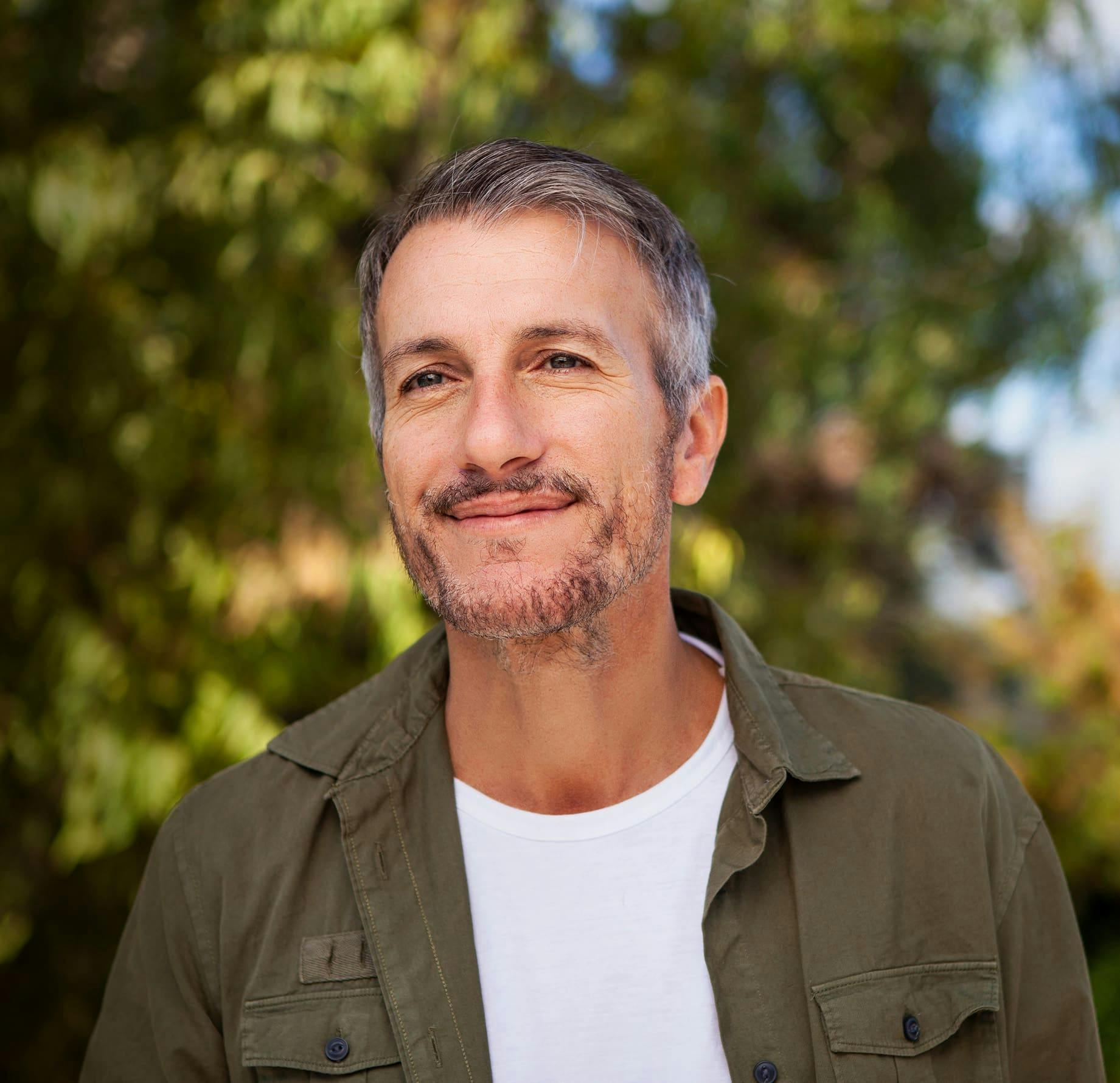 man outdoors smiling