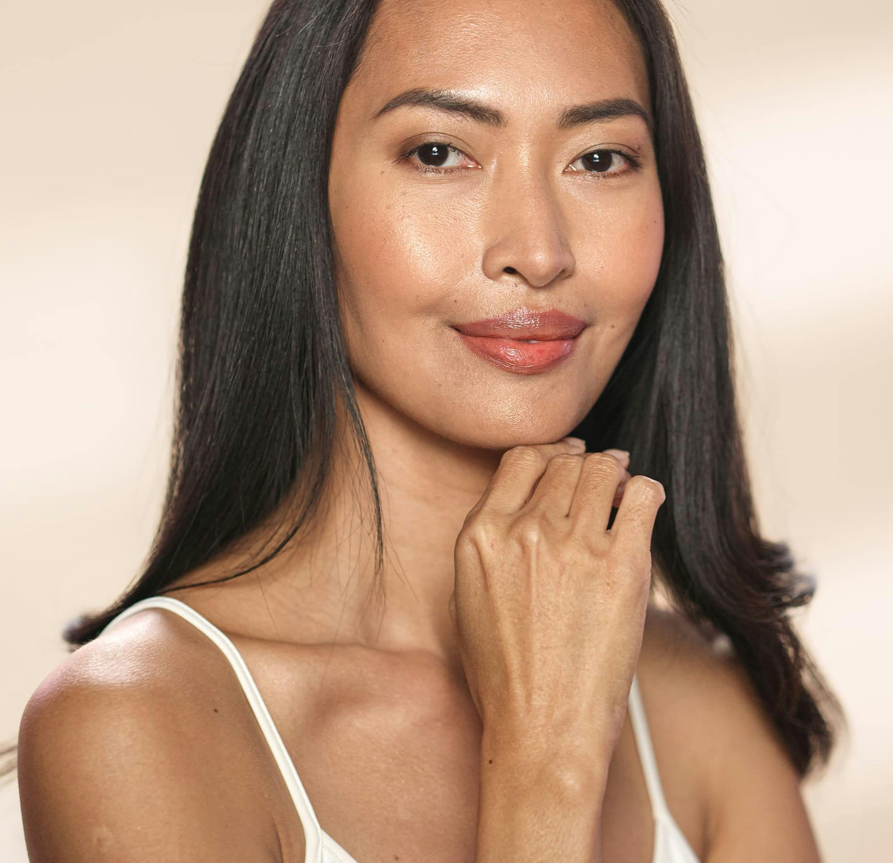 Woman smiling while touching chin