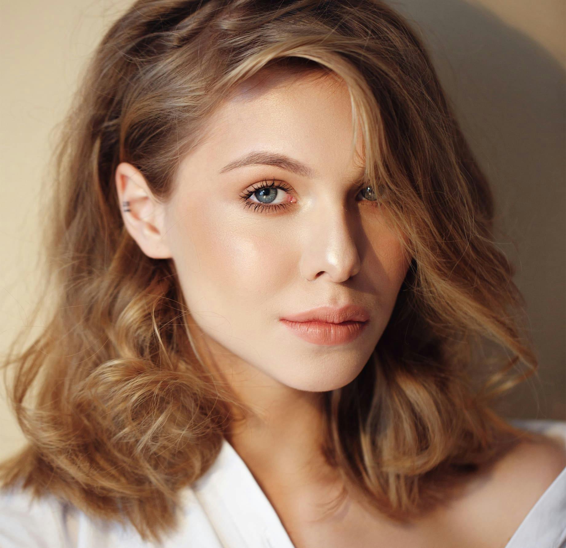 woman with short wavy hair looking forward