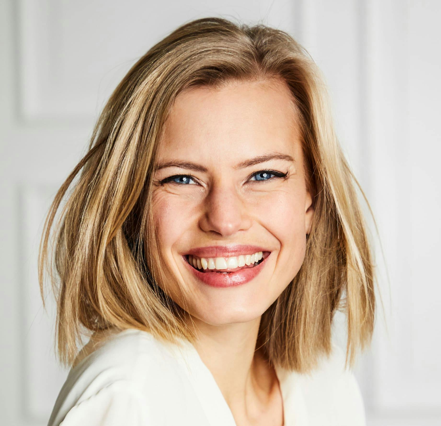 woman with short blonde hair smiling