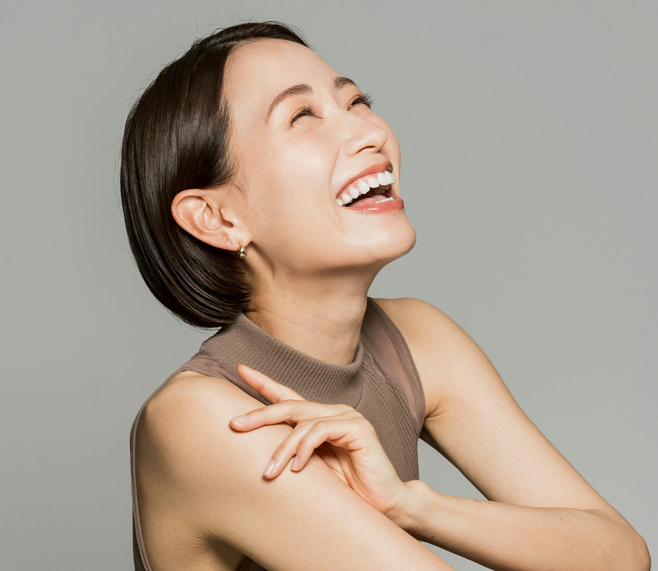 woman leaning back laughing