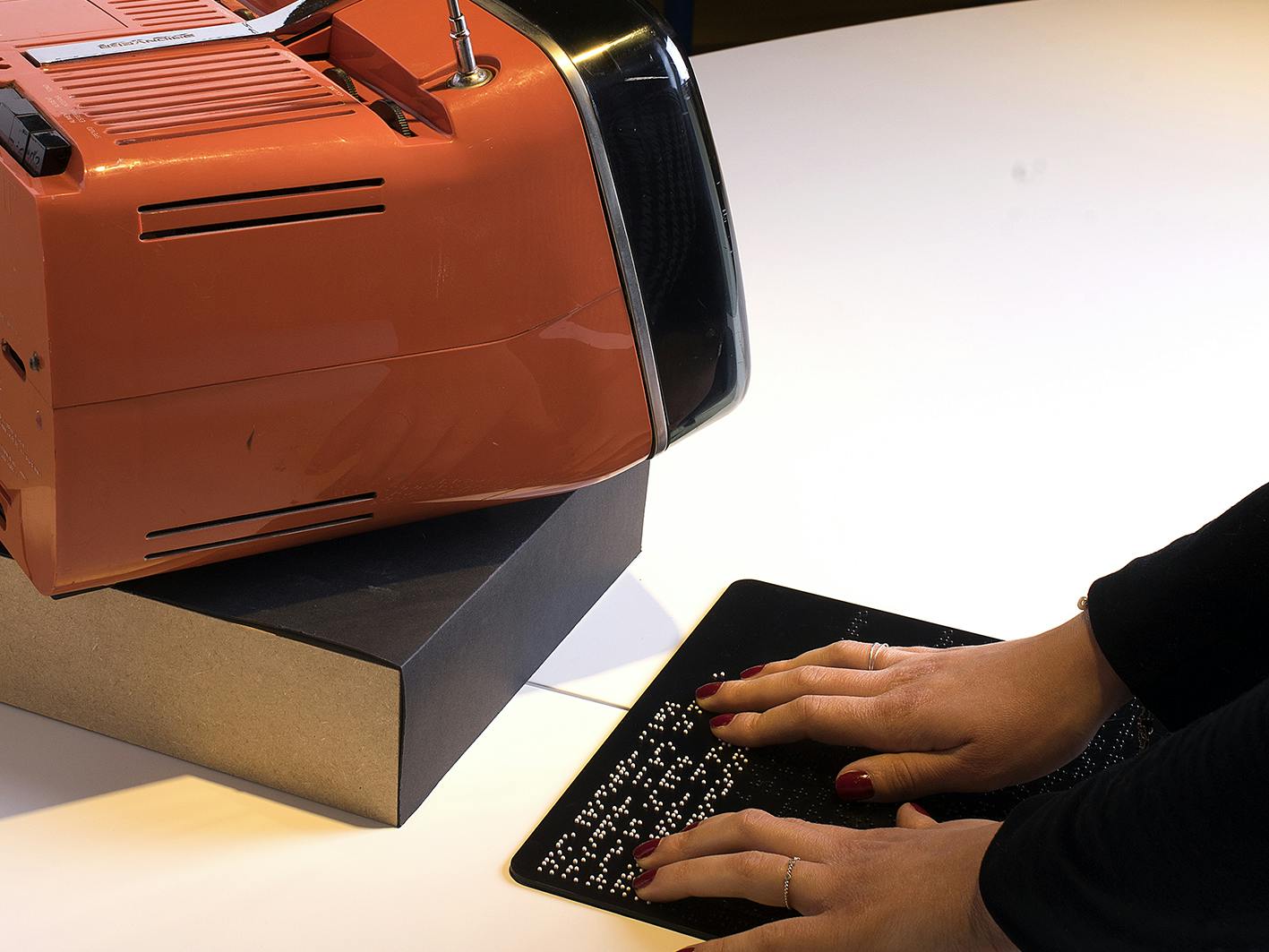 Ancona, Museo Omero, Design Collection. A person reading the Braille caption of the Alvol TV. Ancona, Museo Omero, Design Collection. A person reading the Braille caption of the Alvol TV.
