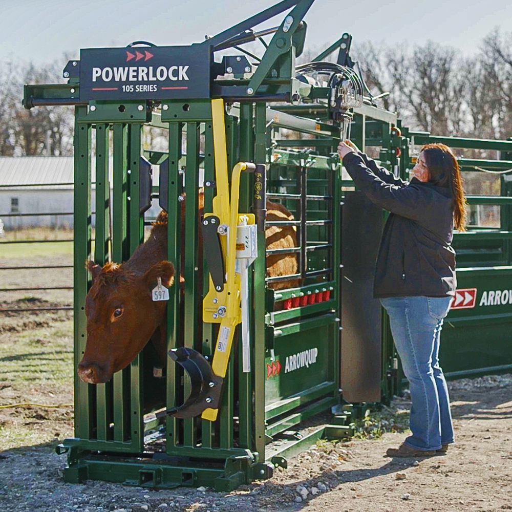 woman rancher using Powerlock 105 Hydraulic Squeeze Chute working a brown cow